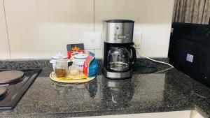a coffee maker sitting on top of a kitchen counter at La Lucia Sleepover in Durban