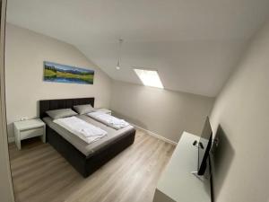 a small bedroom with a bed in a attic at Gaga Residence 15 in Timişoara