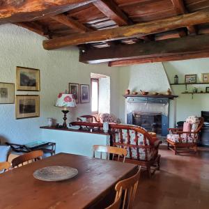 a living room with a table and a fireplace at La Baronessa Country House in Montefiascone