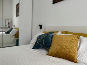 a bed with a yellow pillow on top of it at Maison Chanel in Milan