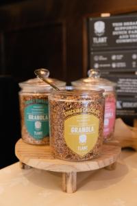 two jars of granola on a wooden stand at Hotel De Kroon Gennep in Gennep