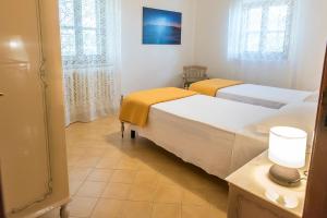 a room with two beds and a lamp on a table at M262 - Marcelli, quadrilocale ristrutturato con terrazzo vista mare 1p in Marcelli