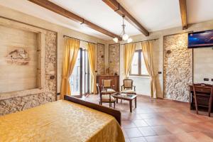 a bedroom with a bed and a tv in a room at Luxury Accommodation in Santa Domenica