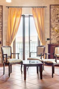 a living room with chairs and a table and a window at Luxury Accommodation in Santa Domenica