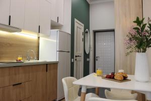 a kitchen with a table with a plate of food on it at Апартаменты Comfort Life 93 in Almaty