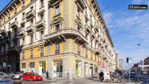 a yellow building on the corner of a street at Dimora Storica in Milan