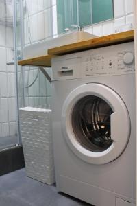 a washing machine in a bathroom with a sink at Апартаменты Comfort Life 93 in Almaty