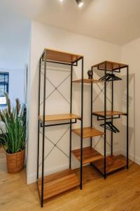 a book shelf with wooden shelves in a room at Brand new bright & luxurious villa in Amsterdam! in Amsterdam