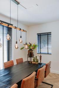 a dining room with a black table and chairs at Brand new bright & luxurious villa in Amsterdam! in Amsterdam