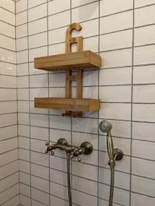 Laliki的住宿－Dom pod kogutem，墙上的木架,带淋浴软管