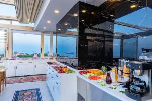 a large kitchen with fruits and vegetables on a counter at Eastanbul Suites in Istanbul
