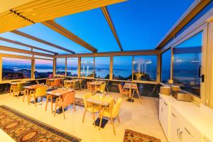 a large room with tables and chairs and windows at Eastanbul Suites in Istanbul