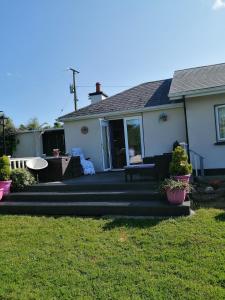 a house with a porch and a patio at An Cúinín in New Ross