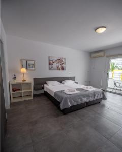 a bedroom with a bed and a table and a window at Nissi avenue studio in Ayia Napa