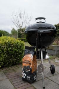 a grill with a bag of chips next to it at Villa Rust-en-Vrede met hottub in Zeewolde