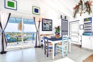 a kitchen and dining room with a table and chairs at Myrtle Cottage in Vlachopoulátika