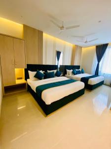a hotel room with two beds with blue pillows at Hotel 51 in Amritsar