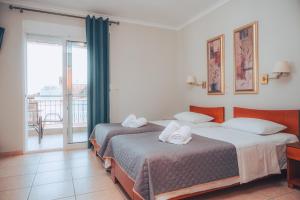 Postel nebo postele na pokoji v ubytování Dionysos Rooms + 37 fotografií