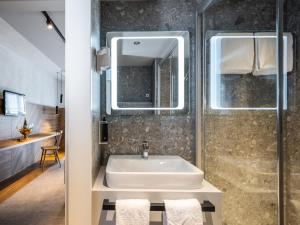 a bathroom with a sink and a shower at ibis Styles Graz Messe in Graz