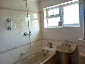 a bathroom with a tub and a sink and a shower at Chelmsford Bed and Breakfast in Broomfield