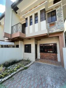 a house with a driveway in front of it at Astra Bella Apartment - Unit 2 in Dumaguete