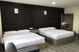Postel nebo postele na pokoji v ubytování Z Stay Inn Hotel