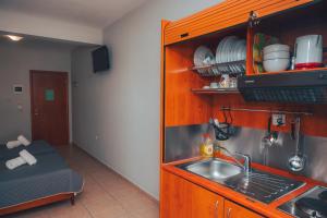 a kitchen with a sink and a counter top at Dionysos Rooms in Olympic Beach