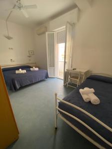 1 dormitorio con 2 camas y ventana en B&B Hotel Lucciola en Cattolica