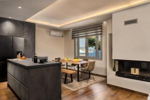 a kitchen and dining room with a table and a counter at Nefeli Luxury Residence in Marathias