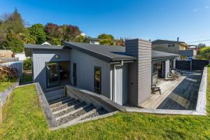 a house with a deck in a yard at If I can dream in Taupo