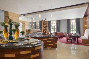 a restaurant with a buffet in a hotel lobby at Bisila Palace in Malabo