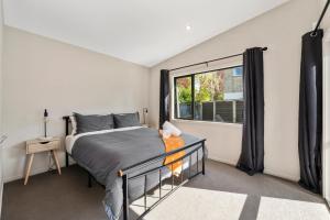 a bedroom with a bed and a window at If I can dream in Taupo