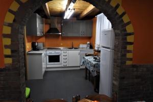 a kitchen with white appliances and a brick wall at PUENTECUERVO in Pancorbo
