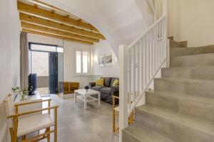 a living room with a staircase and a couch at Holiday Home Casa Sant Pere by Mauter Villas in Ciutadella