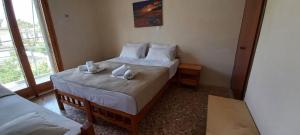Postel nebo postele na pokoji v ubytování Villa Froso