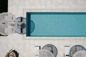 an overhead view of a swimming pool with fans at Cresto Iconic Villa, with Heated Spa Whirlpool, By ThinkVilla in Angeliana