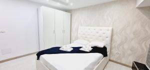 a white bedroom with a bed with towels on it at ELEGANT 3 BEDROOMS, Wifi free in Adeje