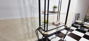 a glass shelf with plants on a checkered floor at ELEGANT 3 BEDROOMS, Wifi free in Adeje