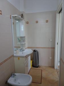 La salle de bains est pourvue d'un lavabo et d'un miroir. dans l'établissement Appartamento Verdi Colline, à Moniga del Garda