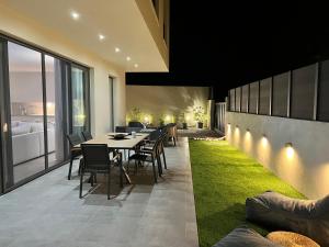 a dining room with a table and some grass at LUXURY VILLA SEVEN in Skiathos Town