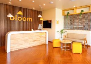 a room with a couch and a table and chairs at Bloom Hotel - Golf Course Road, Sector 43 in Gurgaon