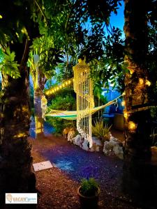 a hammock in a garden at night with lights at Villa Artemis in Larnaka