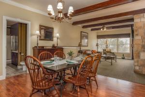 a dining room and living room with a table and chairs at Branson's Great Rock Retreat in Branson