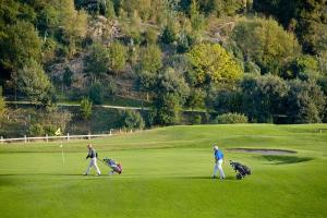 a group of three people walking on a golf course at ATERIAN LOFT 2 in Zarautz