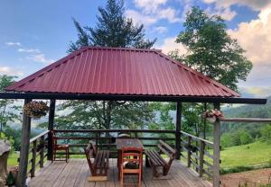 a gazebo with chairs and a red roof at Katun Lanista-Kolibe Bogavac in Mojkovac