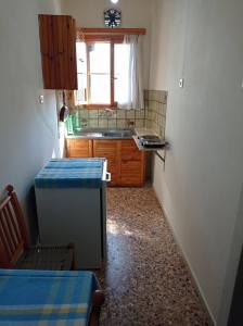 a small kitchen with a sink and a refrigerator at Villa Froso in Pefki