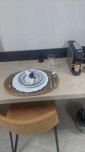 a table with a plate of food and a printer at Studio Vila Mariana in Sao Paulo