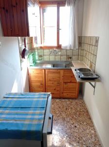 a small kitchen with a sink and a window at Villa Froso in Pefki