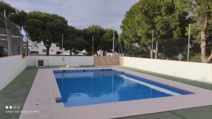 a swimming pool in a backyard with a white fence at Balcon de San Jose in San José