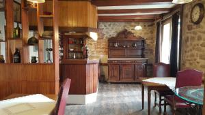 a kitchen and dining room with a table and chairs at L'ancienne Gendarmerie in Saint-Laurent-sur-Gorre